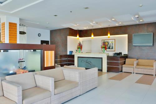 a lobby with two chairs and a waiting room at Alpa City Suites Hotel in Cebu City