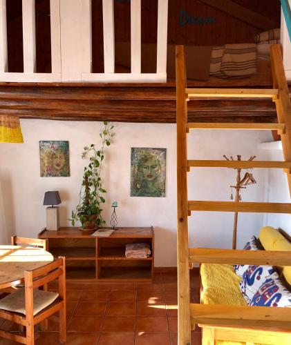 a room with a bunk bed and a desk at Casinhas da Figueira in Budens