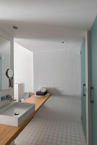 a bathroom with a sink and a mirror at Hotel Restaurant Santiago in Hendaye