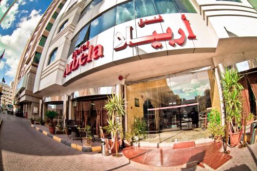 a building with a sign on the front of it at Arbella Boutique Hotel in Sharjah