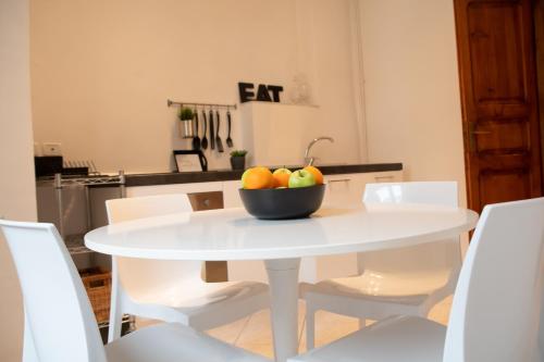 a white table with a bowl of fruit on it at Alloggio Turistico al Civico n 32 in Foligno