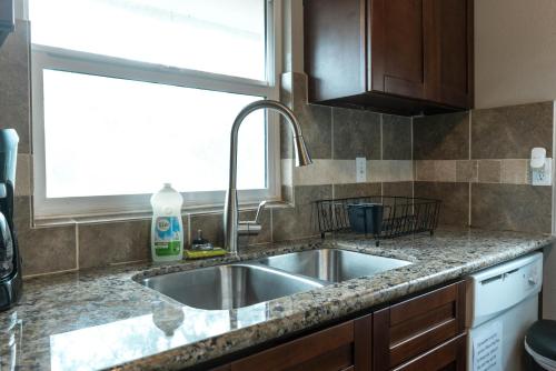 a kitchen with a sink and a window at East Downtown Bungalow in Houston