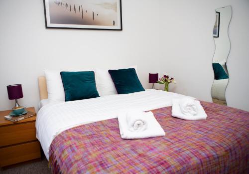 a bedroom with a bed with towels on it at Apt 2, Opera House by Indigo Flats in London