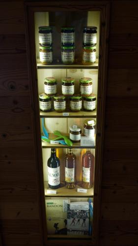 a refrigerator filled with lots of jars of honey at Arcanson in Méaudre