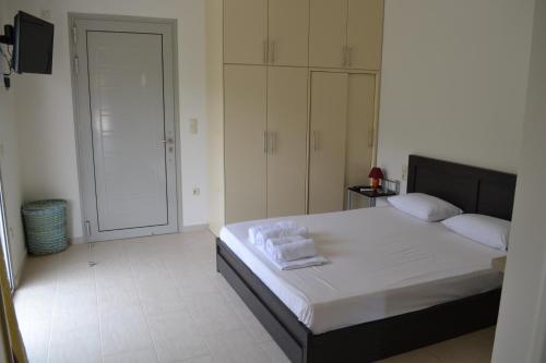 a bedroom with a large bed with towels on it at Av Apartment in Agios Nikitas