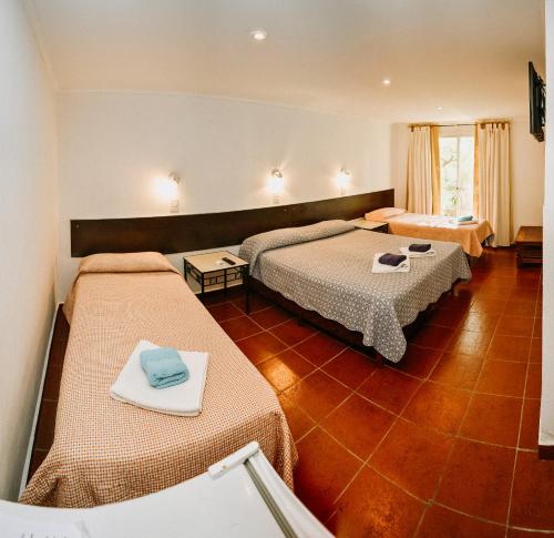a hotel room with two beds in a room at La Candida Hotel in Merlo