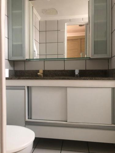 a bathroom with a sink and a mirror at Porto de Iracema Residence in Fortaleza