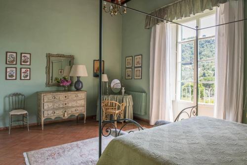 a bedroom with a bed and a dresser and a window at Petrolo in Bucine