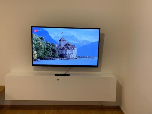 a flat screen tv sitting on a white wall at Anne am Kurpark in Bad Tölz