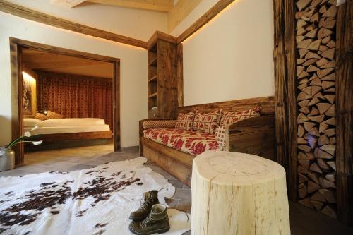 a bedroom with a bed and a table in a room at Olympic SPA Hotel - Adults Only in Vigo di Fassa