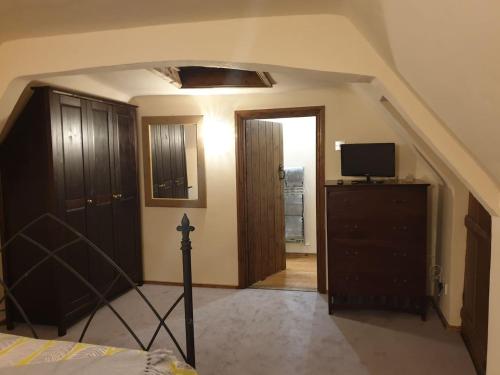 a bedroom with a staircase leading into a room with a bed at The Loft @ Ford House in Yetminster