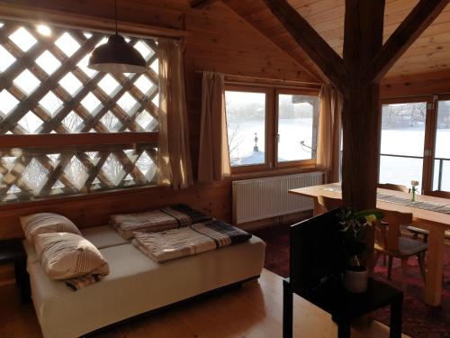 a bedroom with a bed in a room with windows at Koanzhaus, Troadkasten in Franking