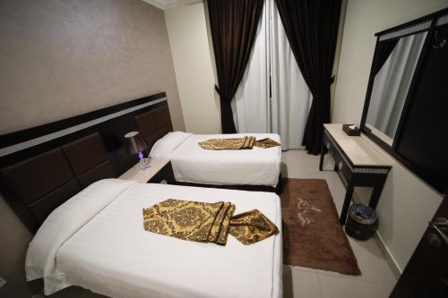 Katil atau katil-katil dalam bilik di Wahaj Hotel Apartments 2