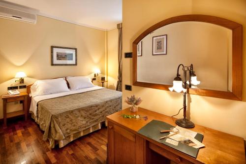 a hotel room with a bed and a desk at La Macchia in Spoleto