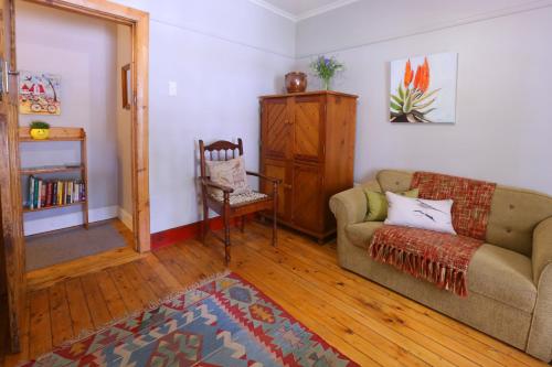 a living room with a couch and a chair at 33 Berg Selfcatering in Swellendam