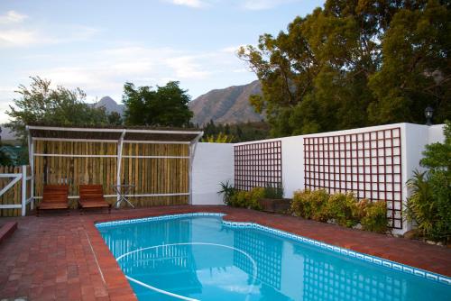 a swimming pool in a backyard with a fence at 33 Berg Selfcatering in Swellendam
