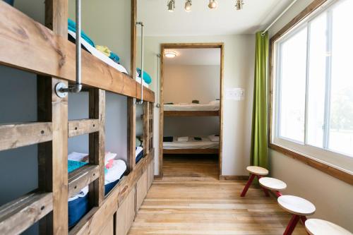 a room with bunk beds and a hallway with a mirror at Hostel Detroit in Detroit