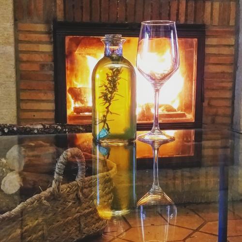 a bottle of wine and a glass on a table at Mas Valoria in Peratallada