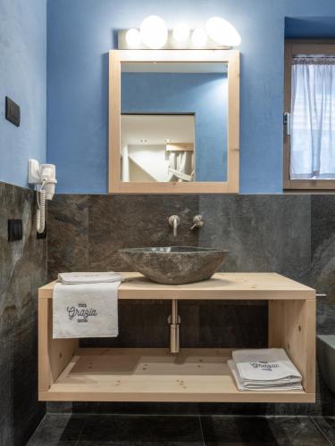 a bathroom with a sink and a mirror at Rifugio Graziani Hütte in San Vigilio Di Marebbe