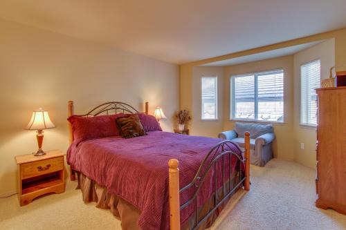 a bedroom with a bed and a chair and a window at Park Pointe Condominiums in Chelan