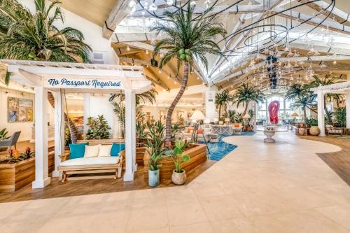 a store with palm trees in the lobby at Margaritaville Cottages Orlando with H2O Waterpark by Rentyl in Kissimmee