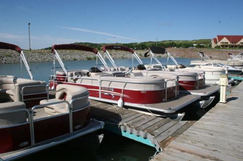 a bunch of boats are docked at a dock at Cedar Shore Resort in Oacoma