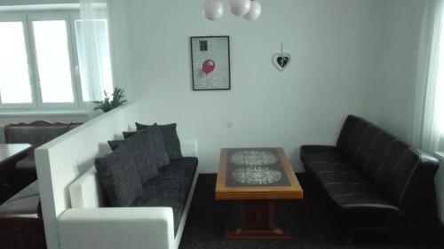 a living room with a couch and a coffee table at Apartmán Saxán Smržovka in Smržovka