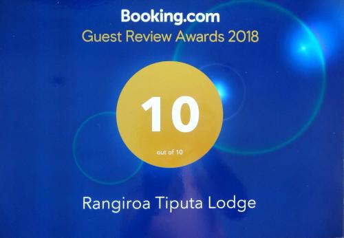 a poster with a yellow circle with the number ten at Pension Tiputa Lodge Rangiroa in Tiputa