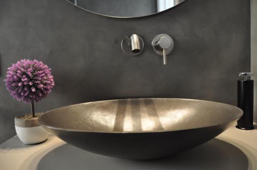 a large bowl sink in a bathroom with a mirror at Casa Rural Cirerer in Sant Llorenç de Morunys