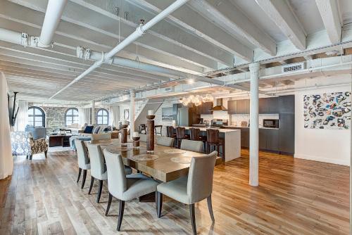 a dining room and kitchen with a table and chairs at Saint Sulpice Lofts by Bakan - Old Montreal in Montreal