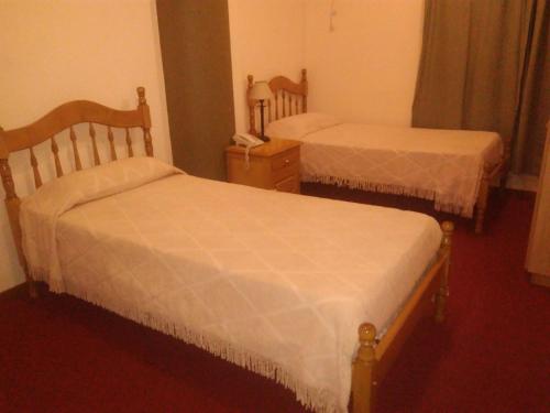 Кровать или кровати в номере HOTEL CONTINENTAL COSQUIN