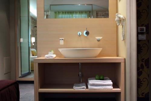 a bathroom with a sink on a counter with towels at El Homs Palace Hotel in Comiso
