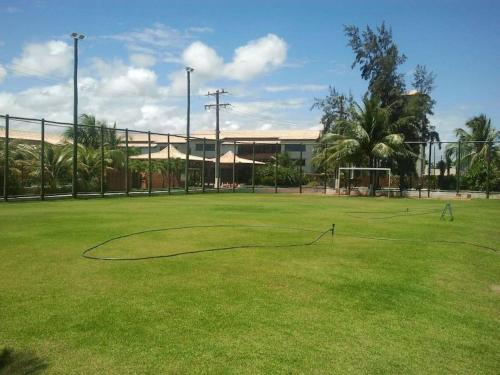 a soccer field with a net in the grass at SUMMER HOUSE GENIPABU in Guarajuba