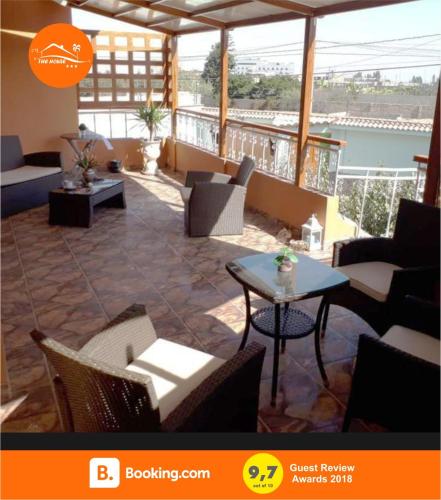 a large room with chairs and tables and a balcony at The House in Tacna