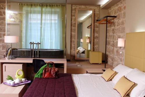a hotel room with a large bed and a sink at El Homs Palace Hotel in Comiso