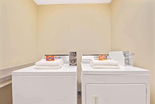 a white sink and a white toilet in a room at Super 8 by Wyndham Waxahachie TX in Waxahachie