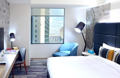 a hotel room with a bed and a desk and a window at HOTEL CHAM CHAM - Taipei in Taipei