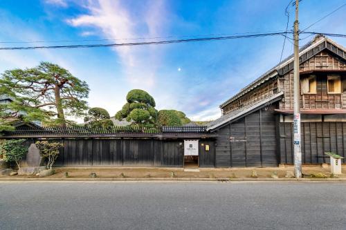 a building with a sculpture of trees on the roof at NIPPONIA Sawara Merchant Town Hotel in Katori