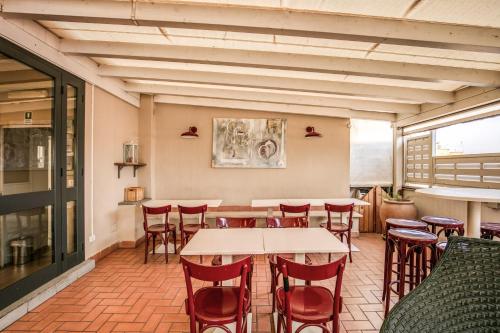 a restaurant with tables and chairs in a room at City Guest House in Rome