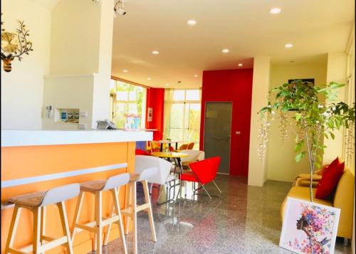 a kitchen with a bar and a table and chairs at Full Moon Resort in Hengchun