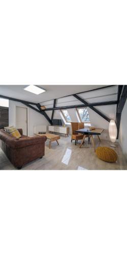 a living room with a couch and a table at Designpension Traumschloss Hotel Garni in Wernigerode