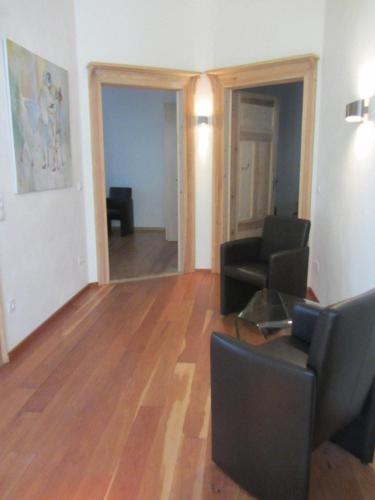a living room with a couch and a table and chairs at Exklusive Gästezimmer Landau in Landau in der Pfalz
