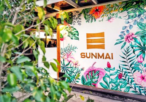 a sign on the side of a bus with flowers at Nacpan Beach Glamping Managed by H Hospitality Group in El Nido