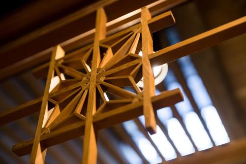 a wooden light hanging from a ceiling at NIPPONIA Sawara Merchant Town Hotel in Katori