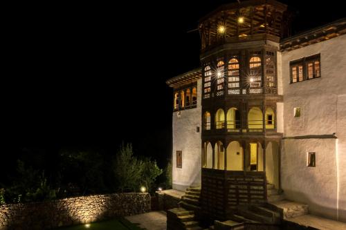 a large building with a tower at night at Serena Khaplu Palace in Khaplu