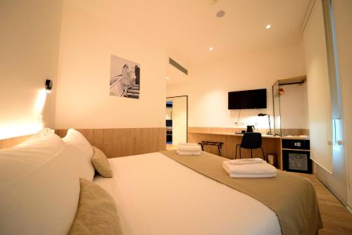 a hotel room with two beds and a television at Air Rooms Rome Airport by HelloSky in Fiumicino