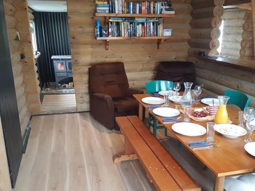 a dining room with a long table and chairs at Lake Stella Mountain Huts in Mt Lyford