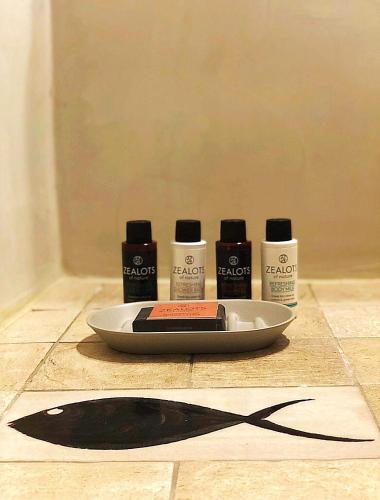 a table with a plate and four bottles of hair products at Mantilida Villa in Emporio Santorini
