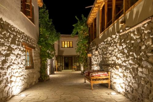 a bench sitting outside of a building at night at Serena Khaplu Palace in Khaplu