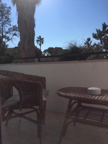 a table and chair on a patio with a tree at A casa di Gio in Lecce